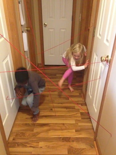 kids playing in string laser maze