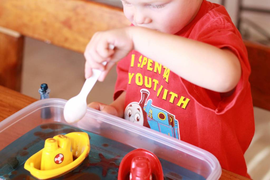 child working on ocean pollution experiment