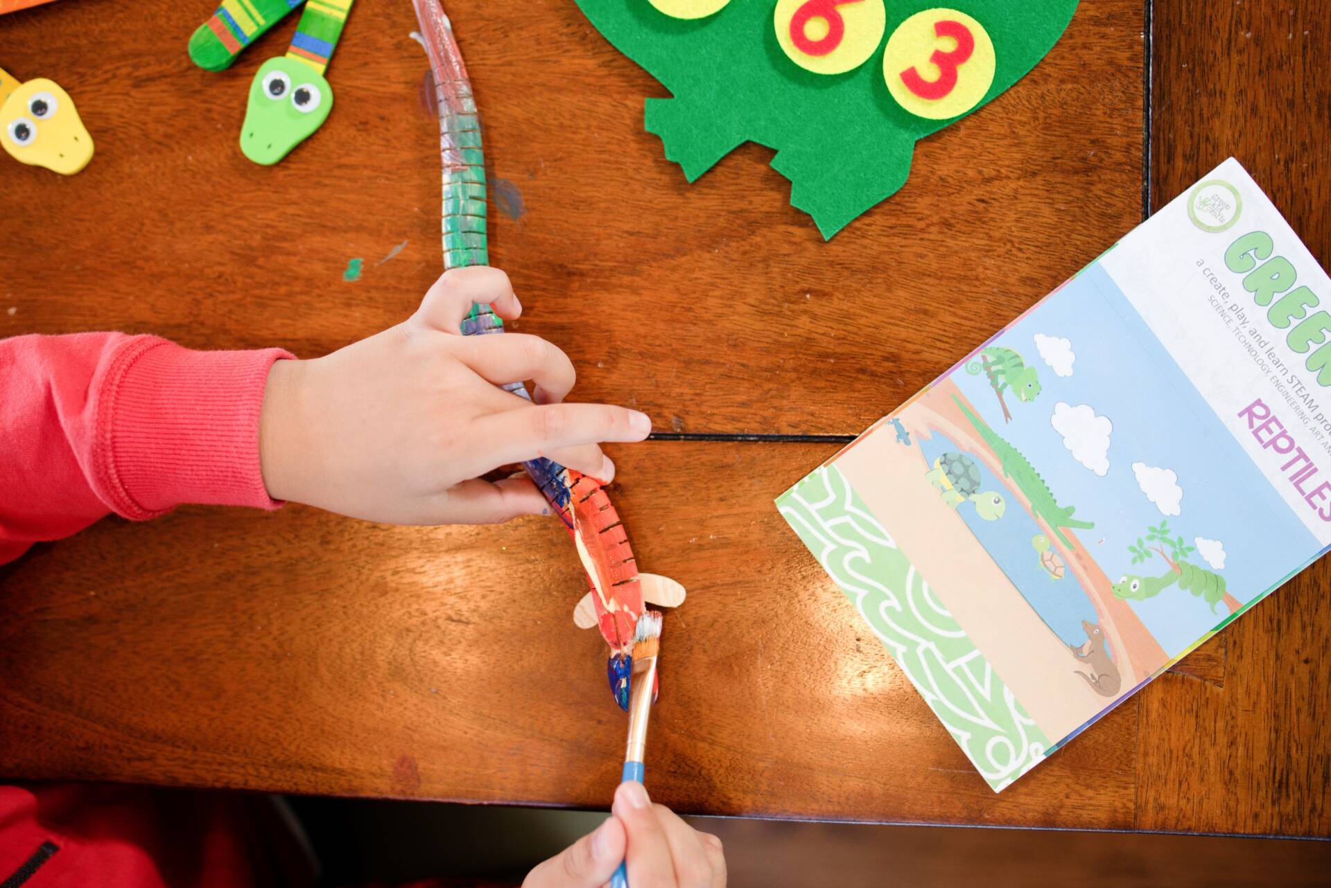 boy doing reptiles kids subscription box