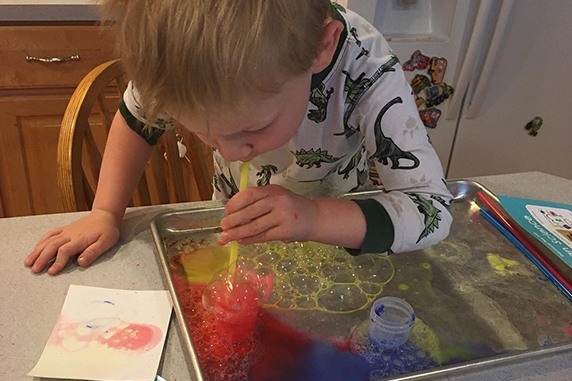 kid playing bubble science experiment