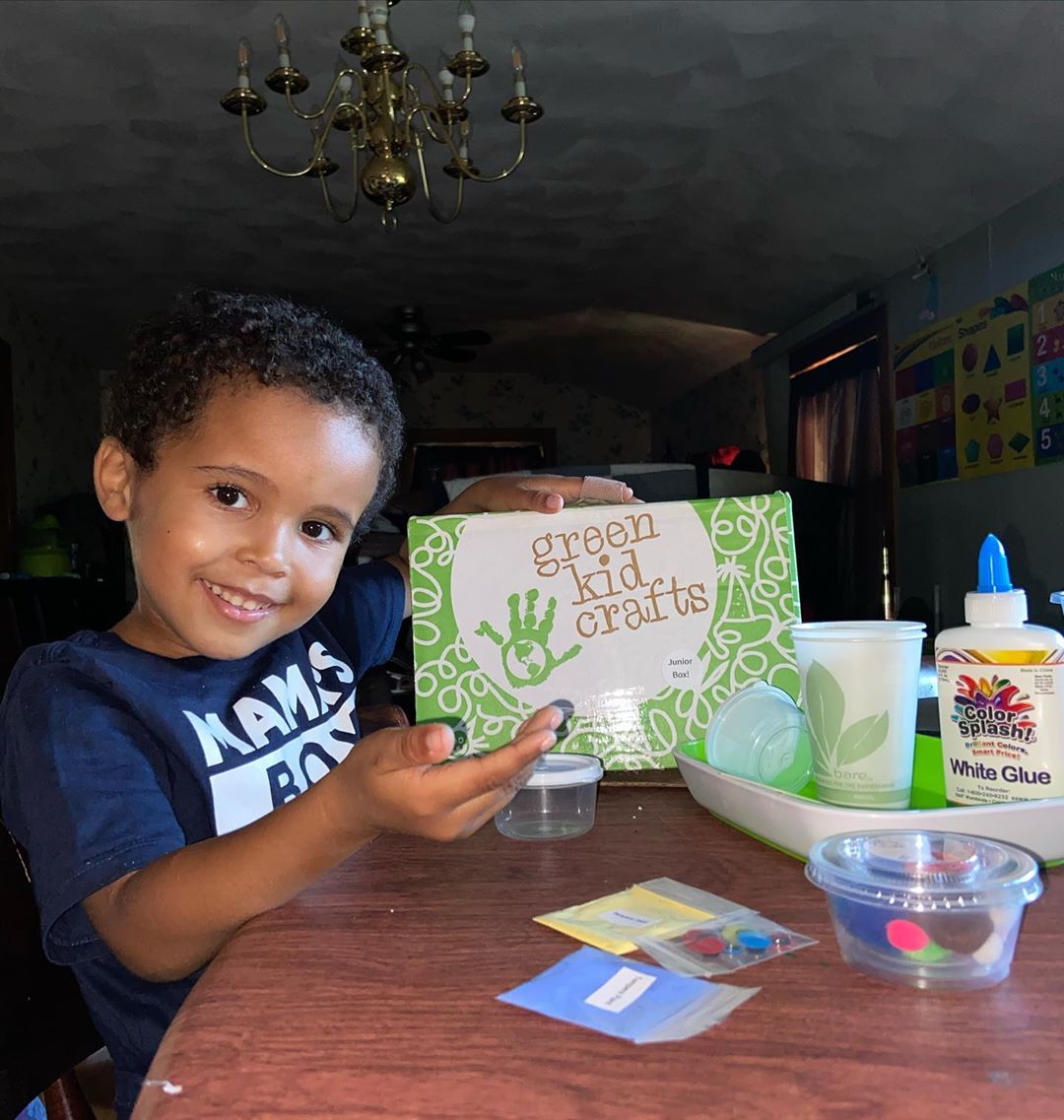 kid discovering activity box