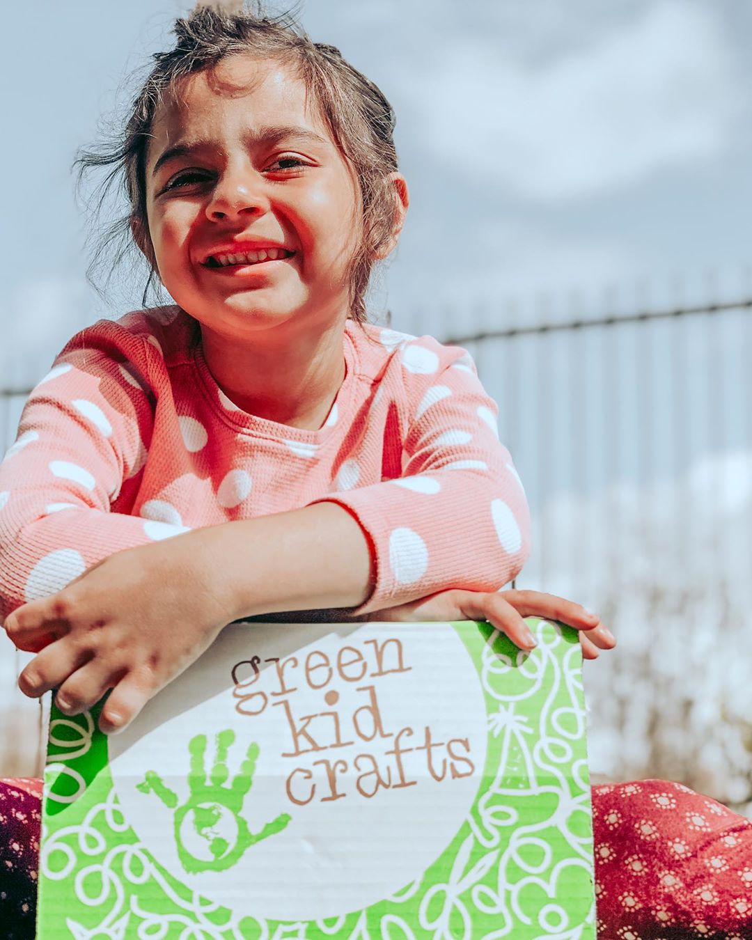 kid cheerfully holding craft box subscription
